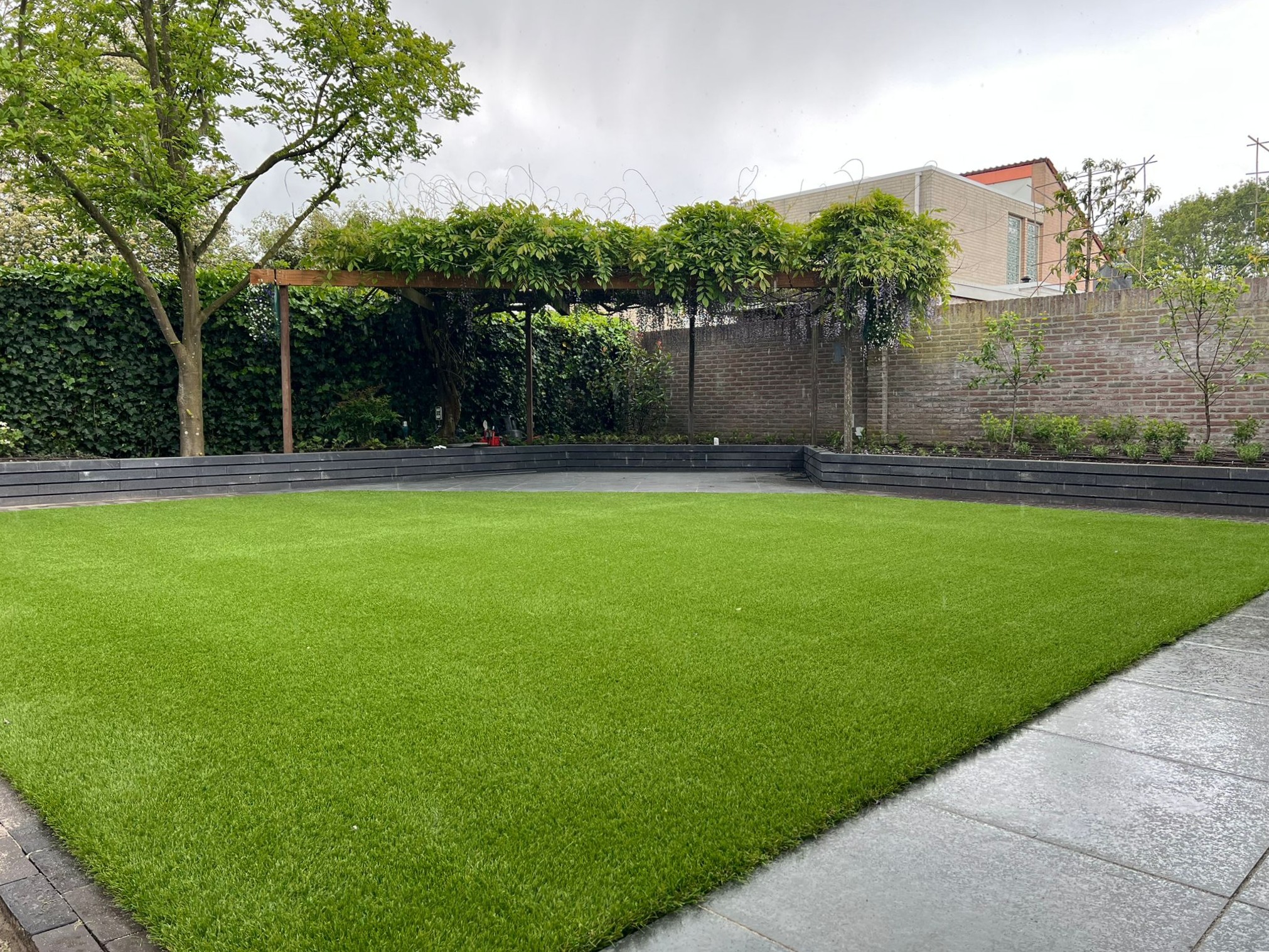 Complete achtertuin renovatie aangevuld met kunstgras